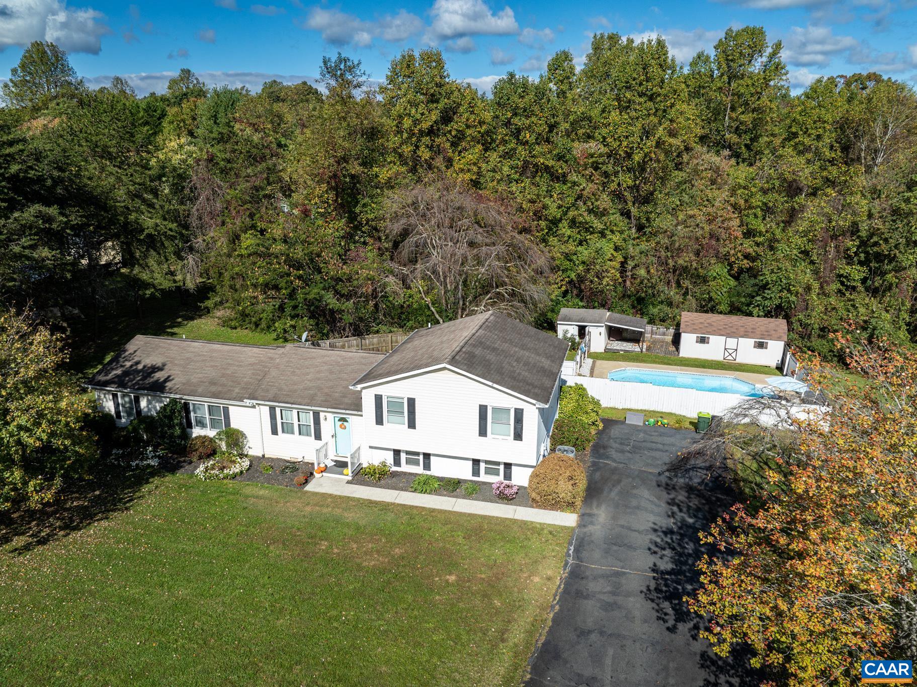 a view of house with outdoor space and trees