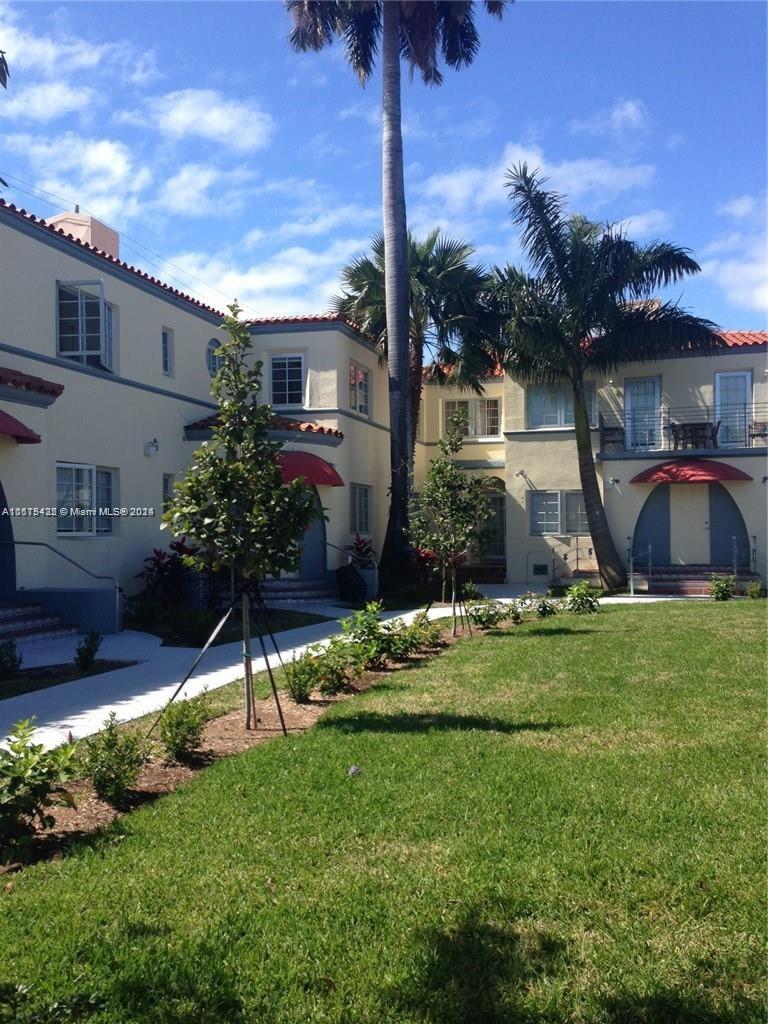 a view of a house with a backyard and a patio