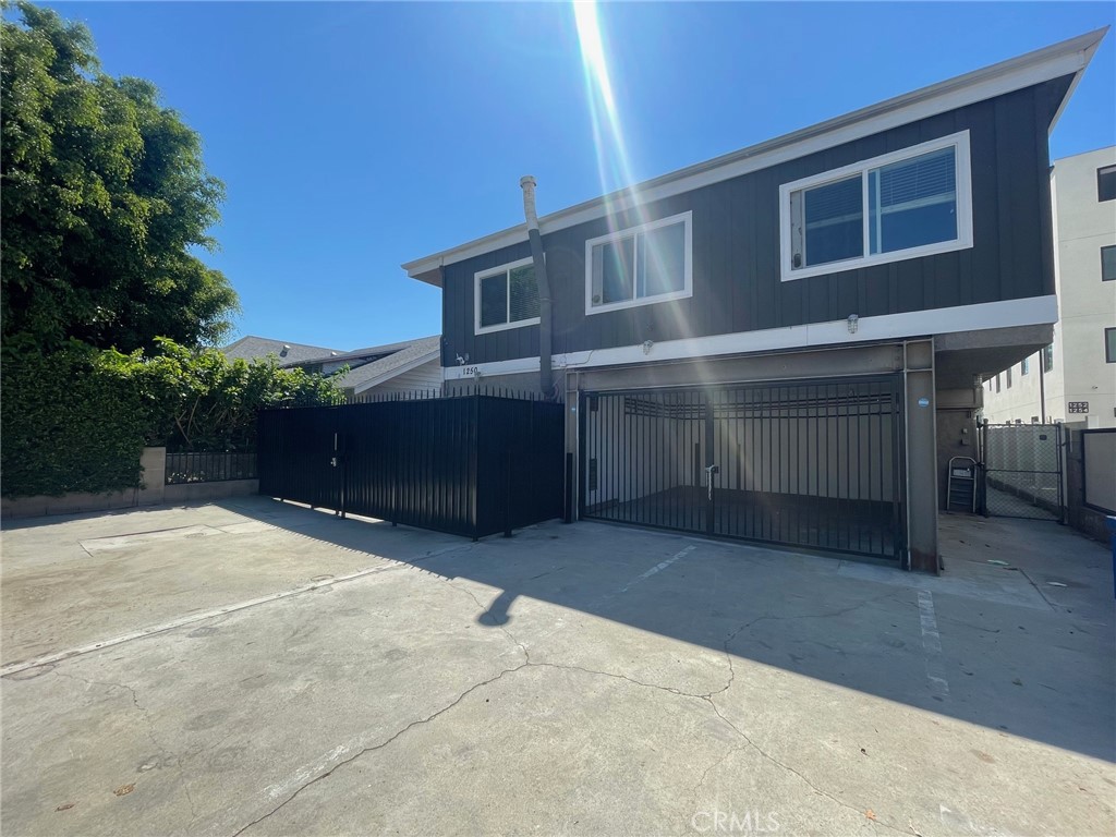 a view of house with outdoor space and parking