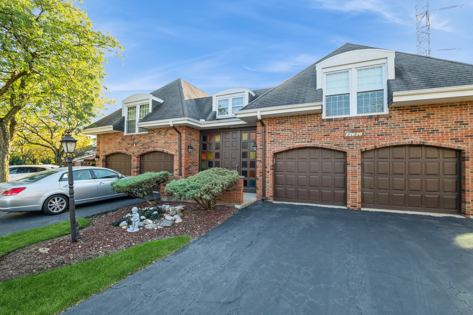 a view of a house with a yard and garage