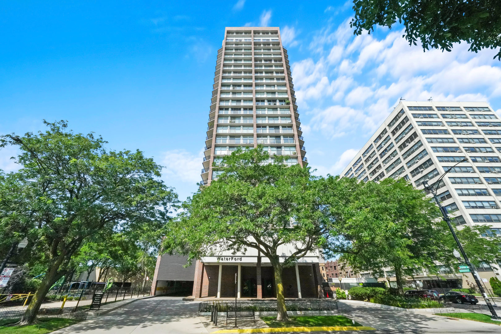 a front view of a building with trees