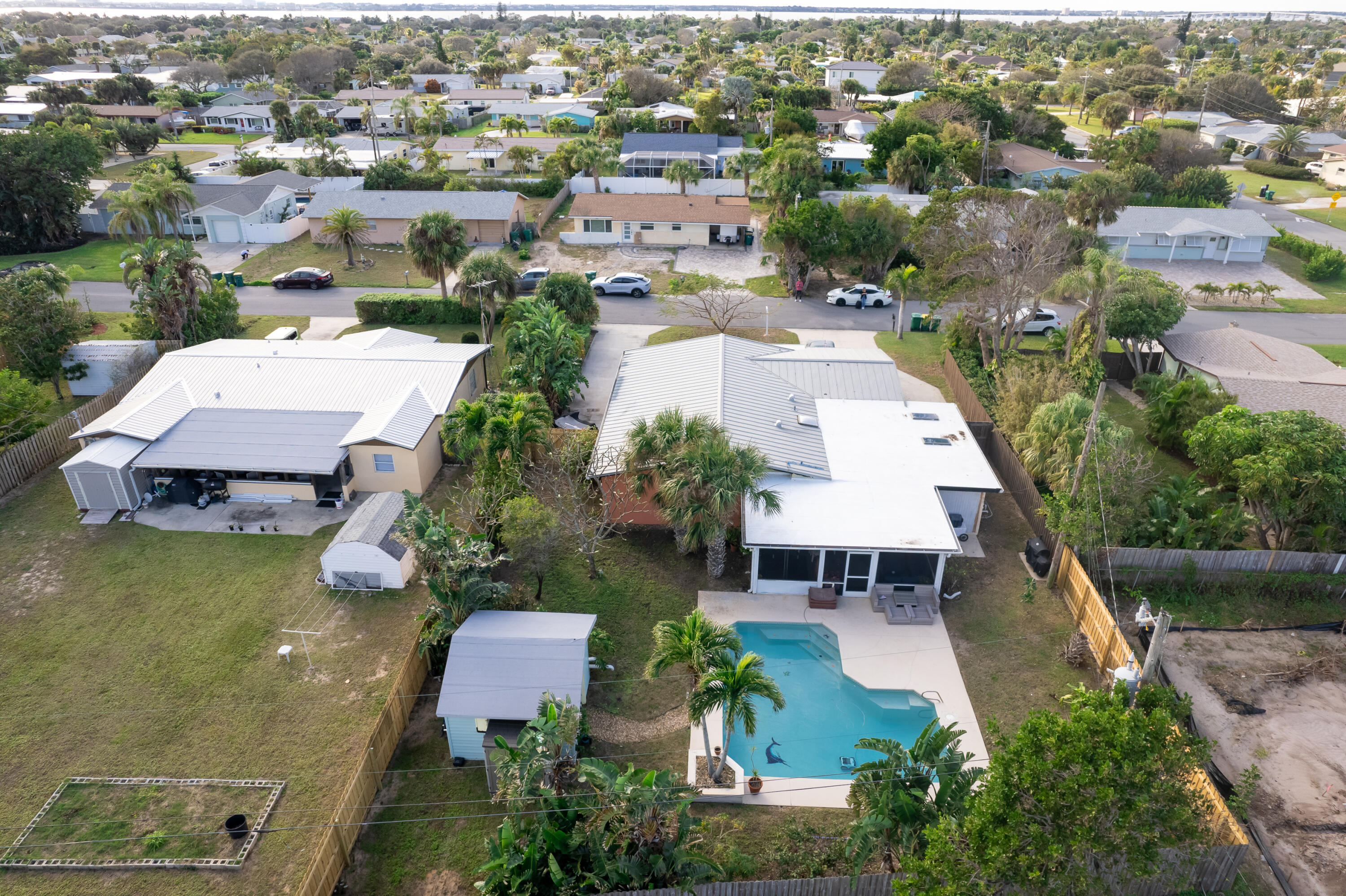 an aerial view of a house with garden space and lake view