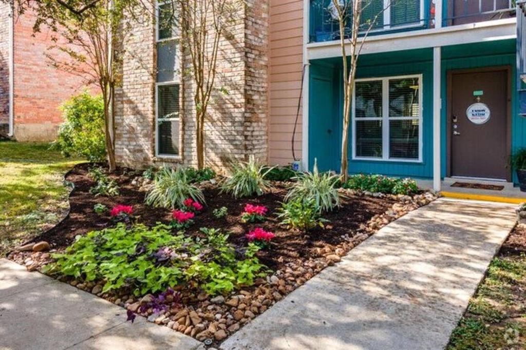 a view of a house with potted plants