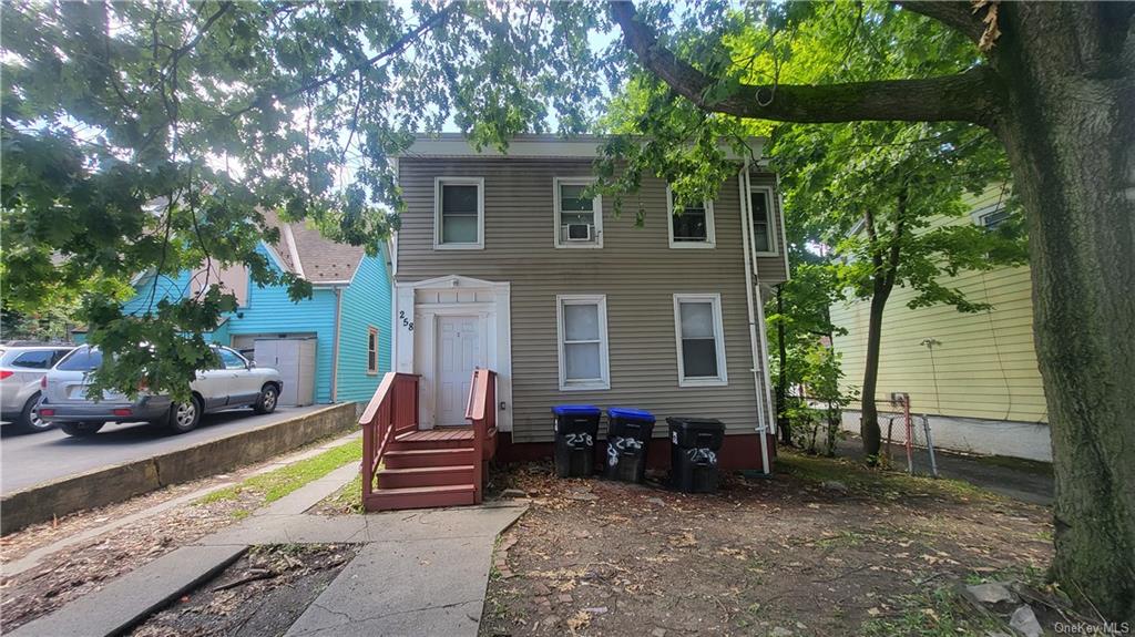 a view of a house with backyard and sitting area