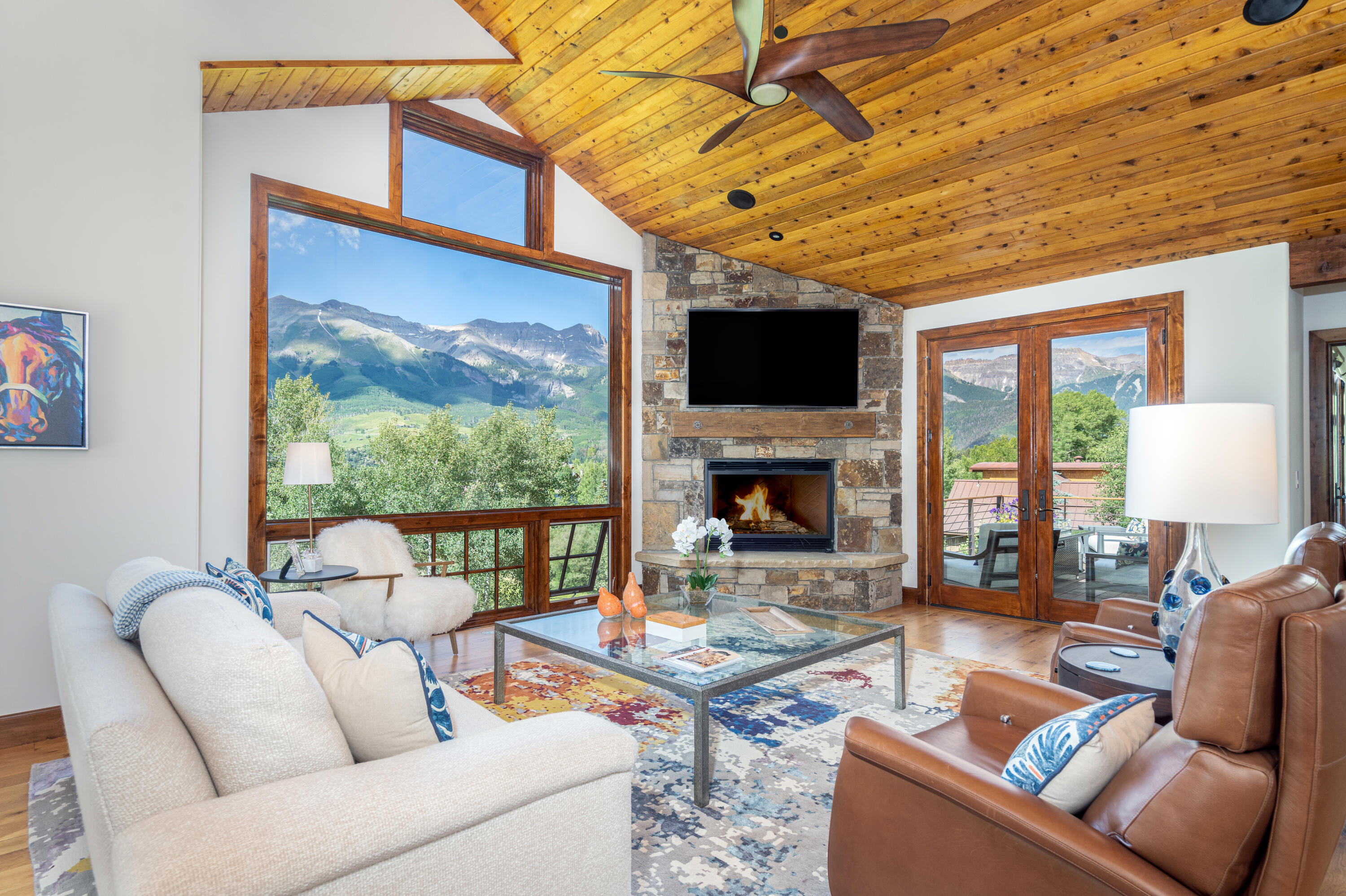 a living room with furniture a fireplace and a flat screen tv