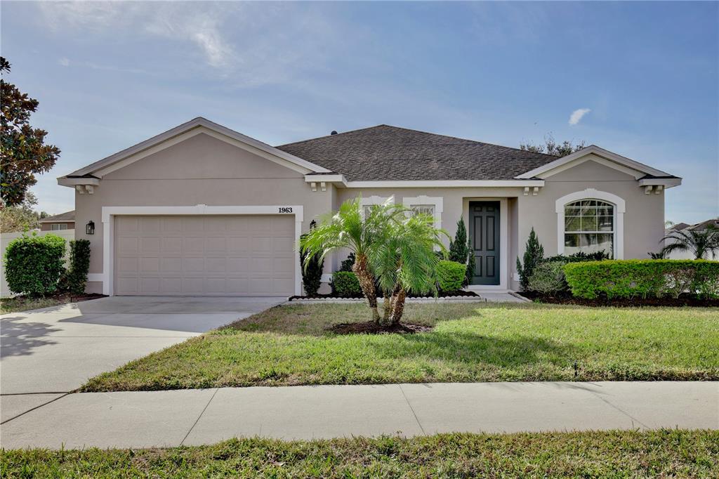 a front view of a house with a yard and garage