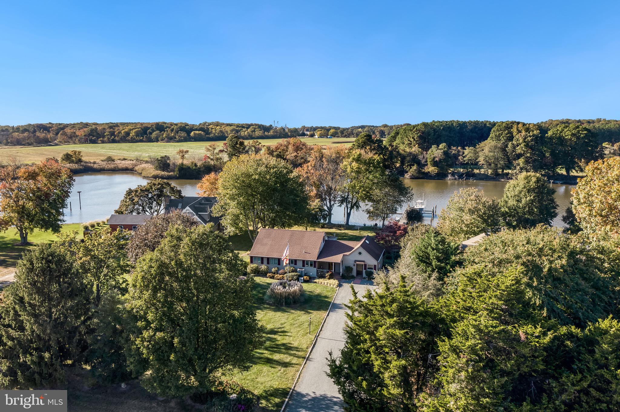 an aerial view of a house with a yard and lake view