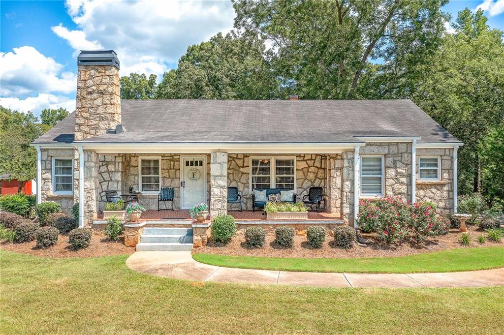 a front view of house with yard and outdoor seating