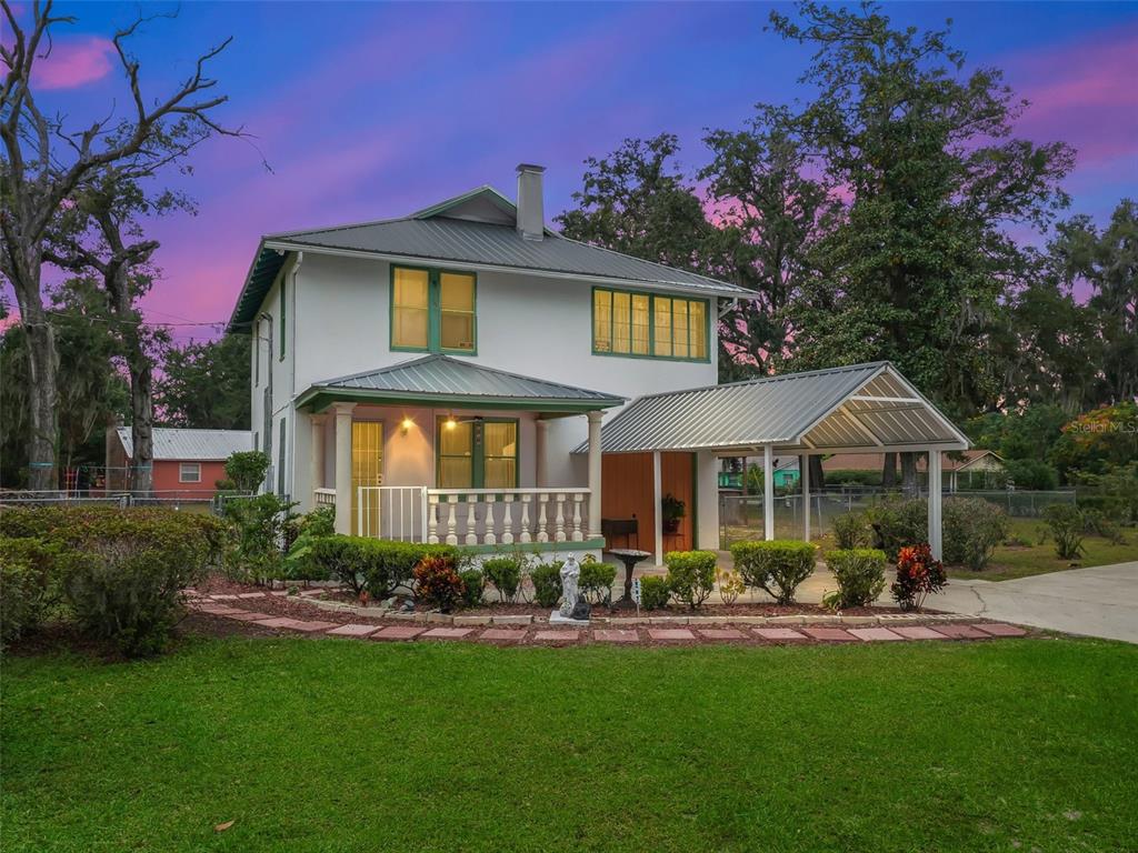 a front view of a house with a yard porch and sitting area