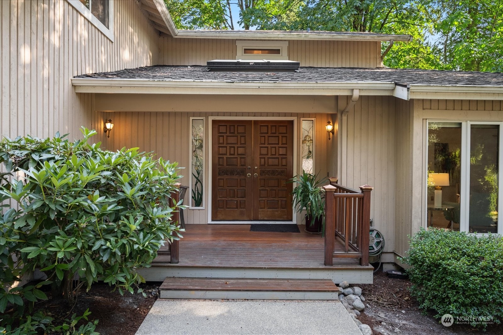 a front view of a house with potted plants