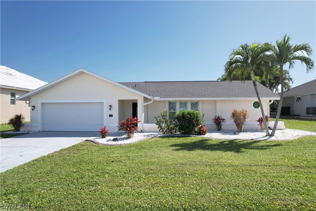 a front view of house with a garden and patio