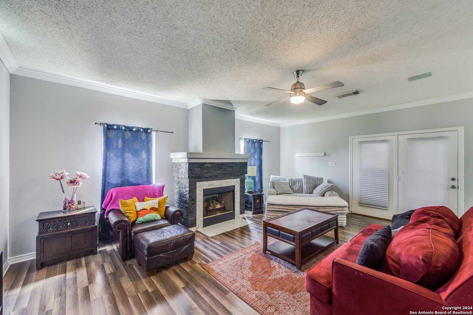 a living room with furniture fireplace and a window