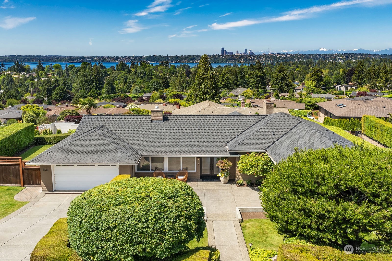 a aerial view of a house with a yard basket ball court and outdoor seating