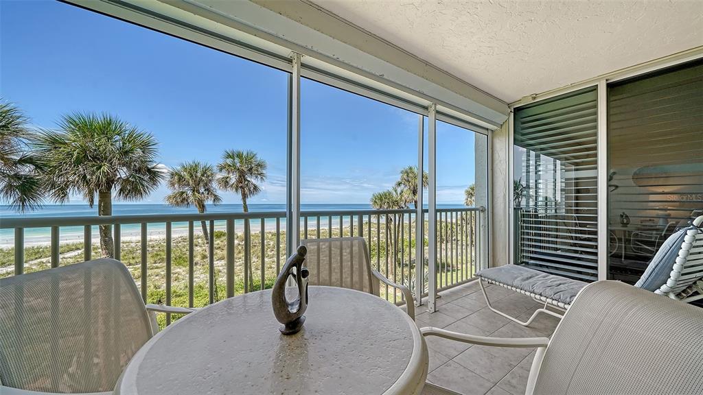 a view of a balcony with floor to ceiling window and wooden floor