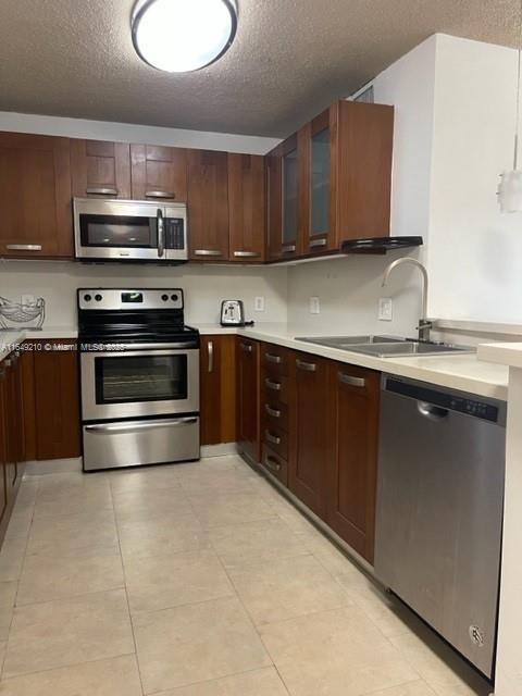 a kitchen with stainless steel appliances granite countertop a sink stove and microwave