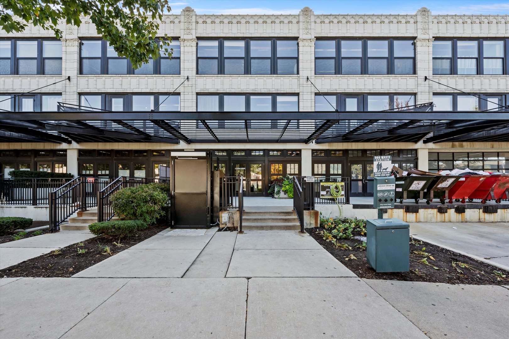 a front view of a building with lots of green space