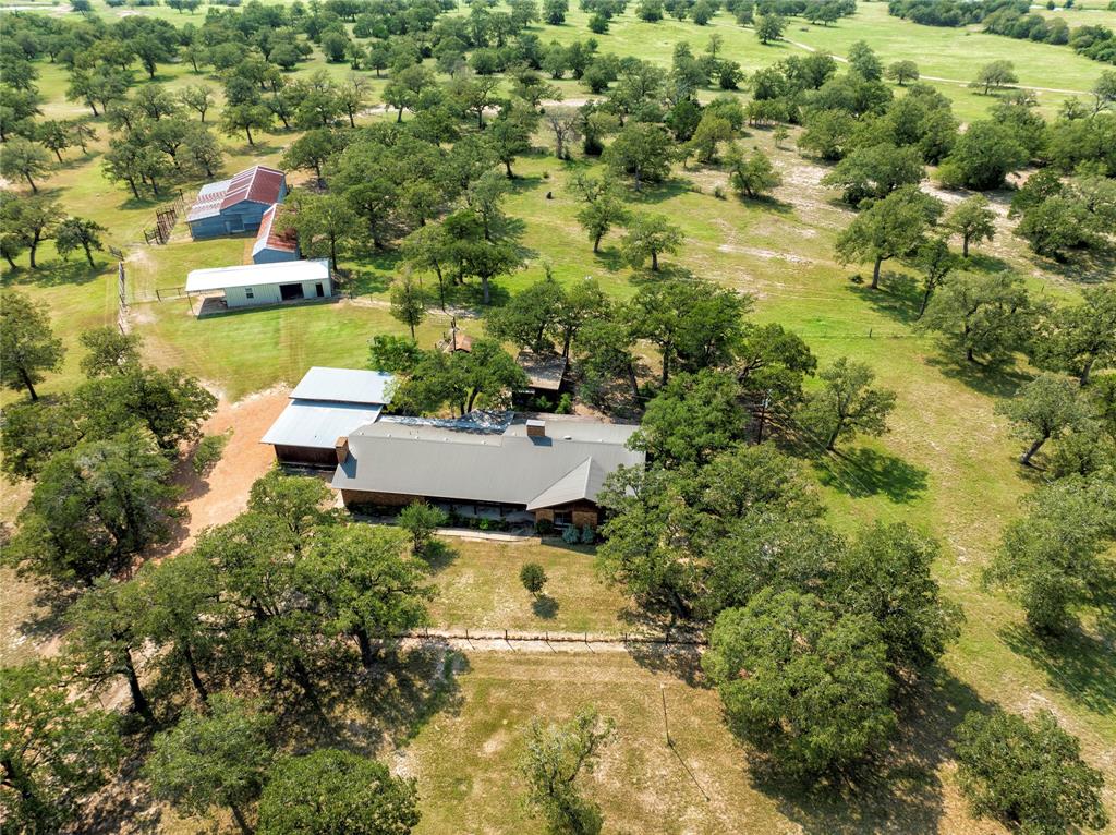 an aerial view of a house with a yard and lake view