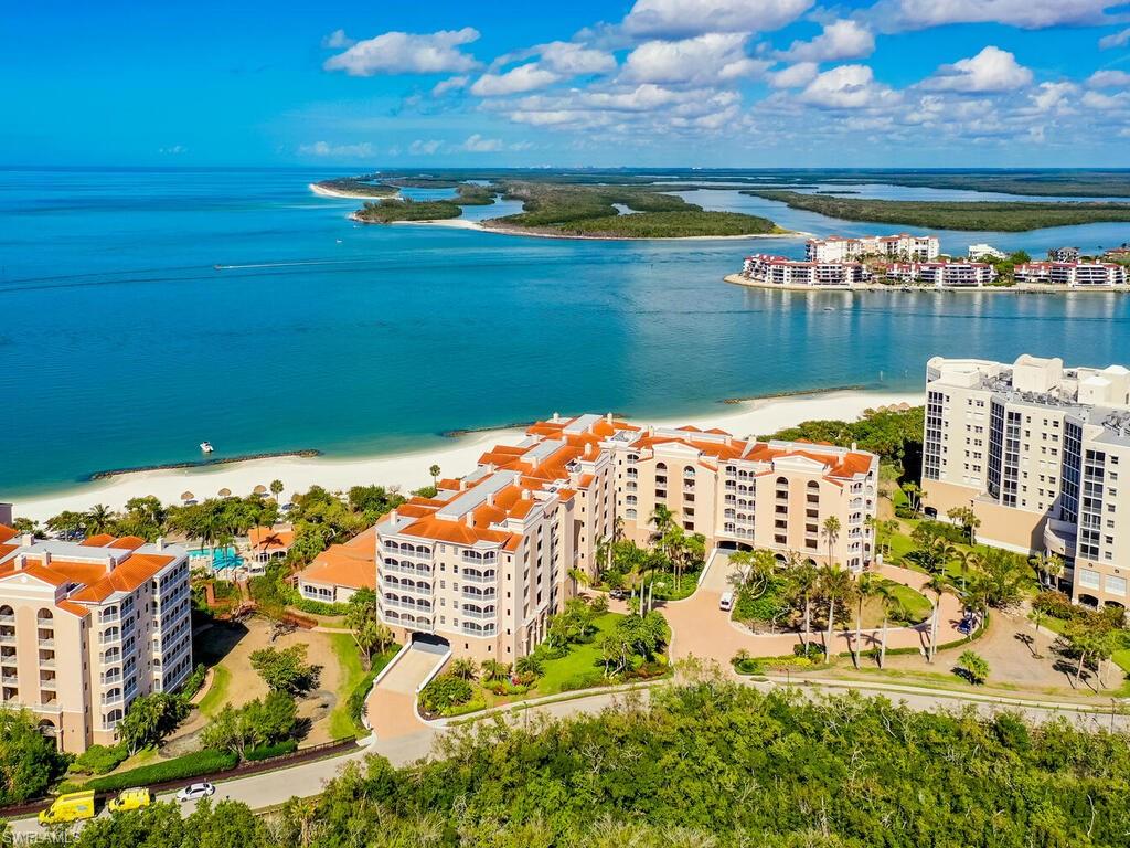 Birds eye view of property with a view of the beach and a water view