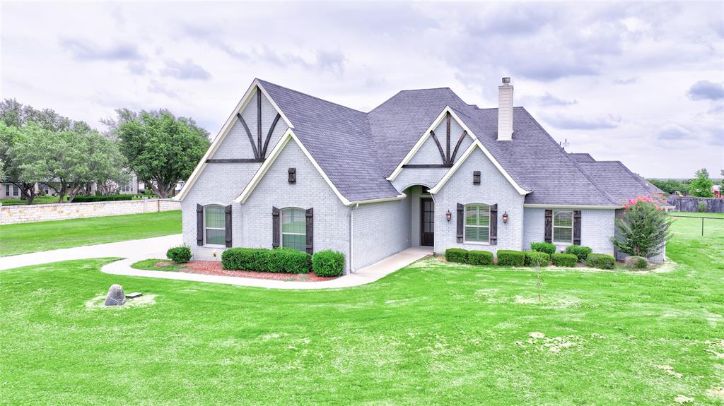 a front view of house with yard and green space