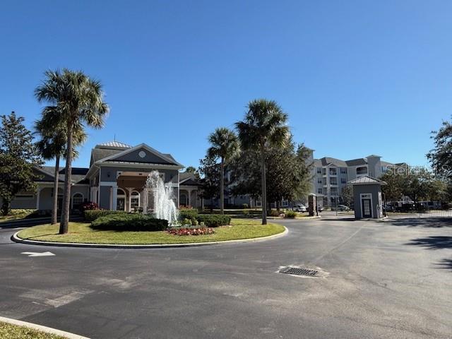 a view of the white house with a yard and palm trees