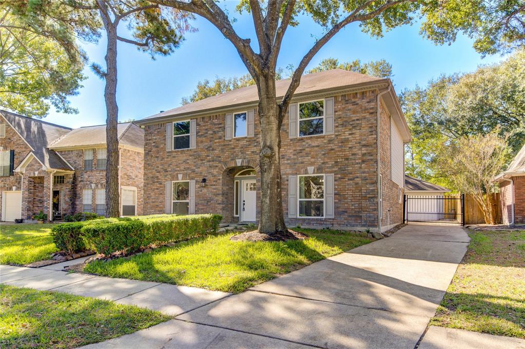 Welcome home to 16827 Scenic Gardens Drive! This beautiful home boasts incredible curb appeal with its charming brick exterior, manicured lawn with a gated driveway