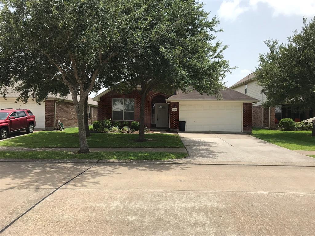 a view of a house with a yard with a street