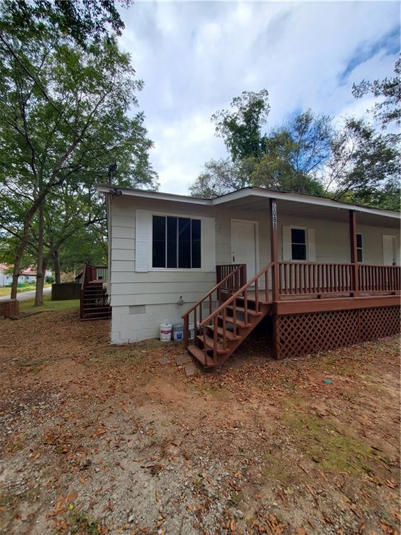 a view of a house with a yard and wooden fence