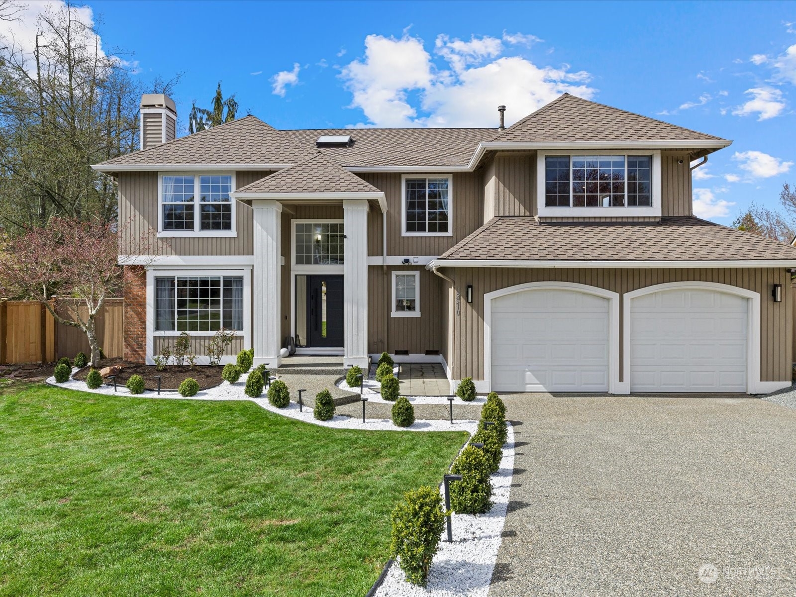 a front view of a house with garden