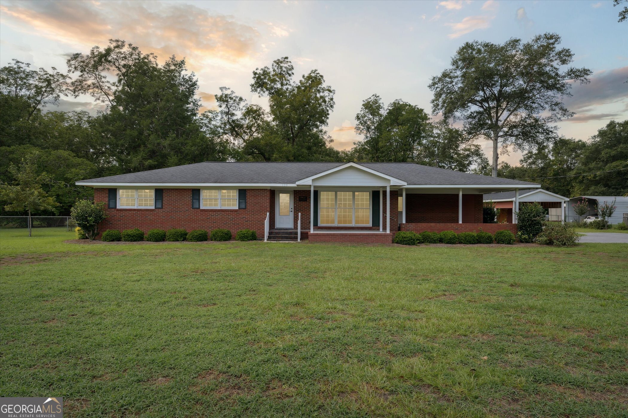 a front view of a house with a garden