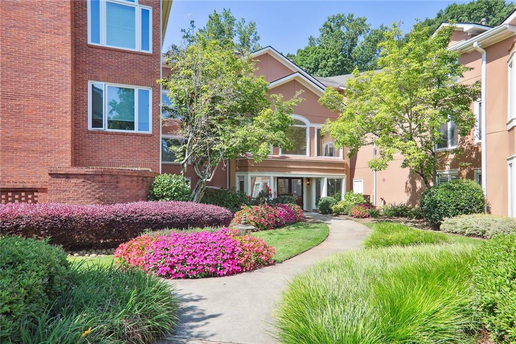 a front view of a house with a yard and outdoor seating