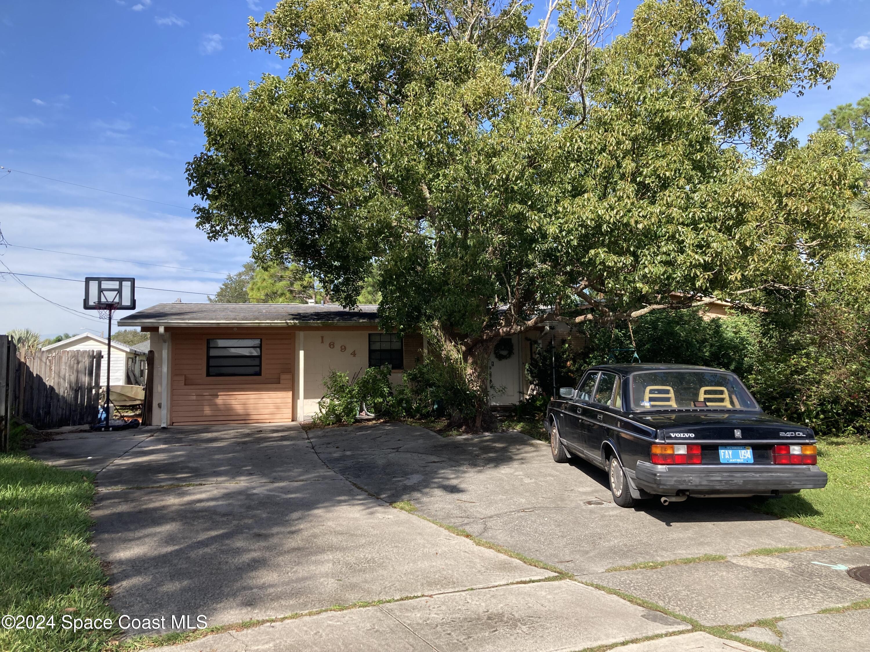 a view of a car parked in front of a house