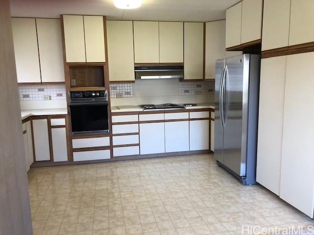 a kitchen with stainless steel appliances granite countertop a refrigerator stove and microwave