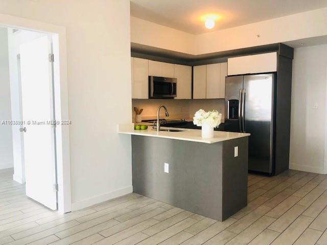 a kitchen with a refrigerator and a microwave