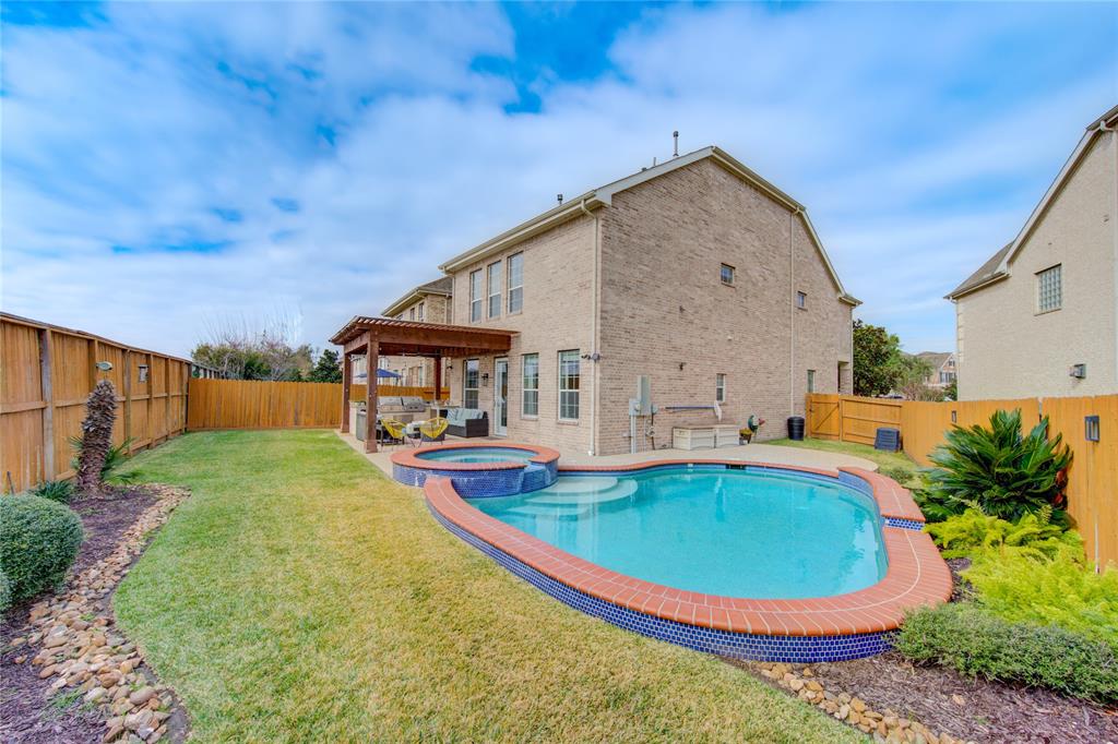 a swimming pool with outdoor seating yard and barbeque oven