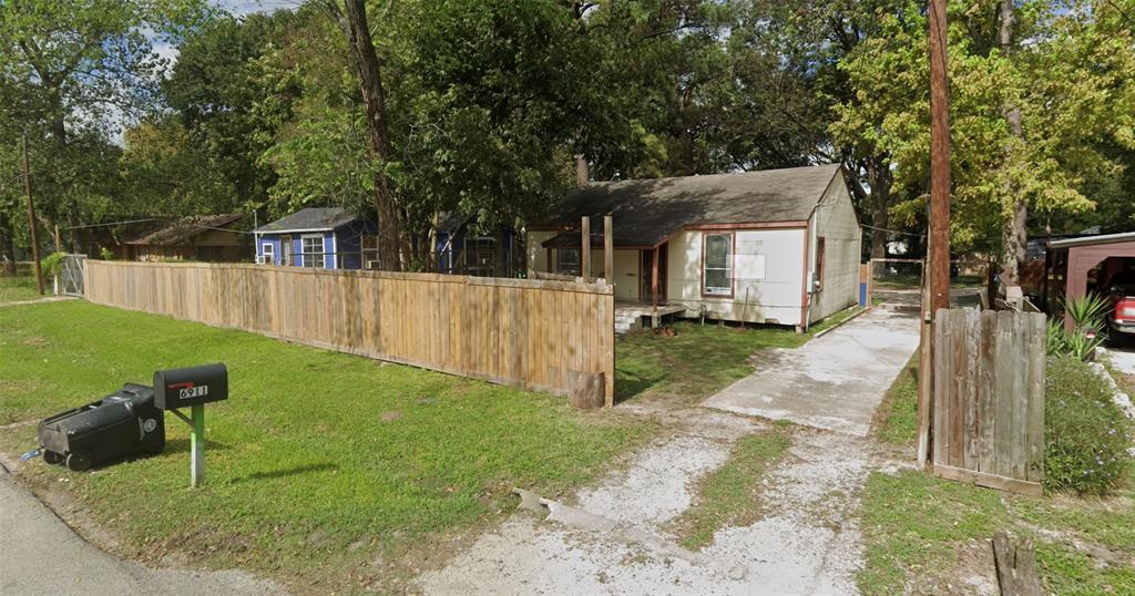 a backyard of a house with table and chairs