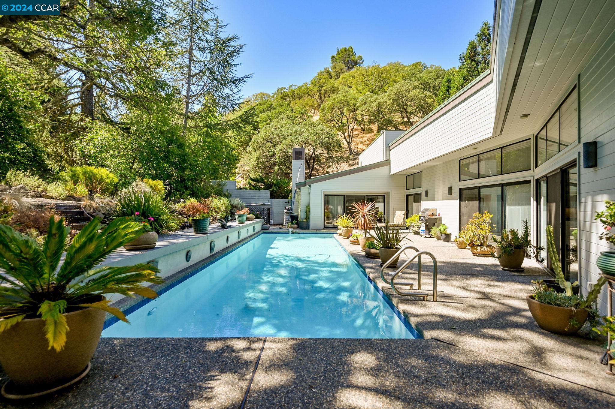 a view of a house with backyard porch and sitting area