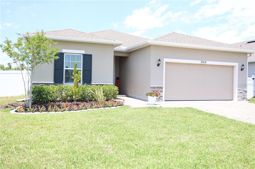 a view of a house with a yard and garage