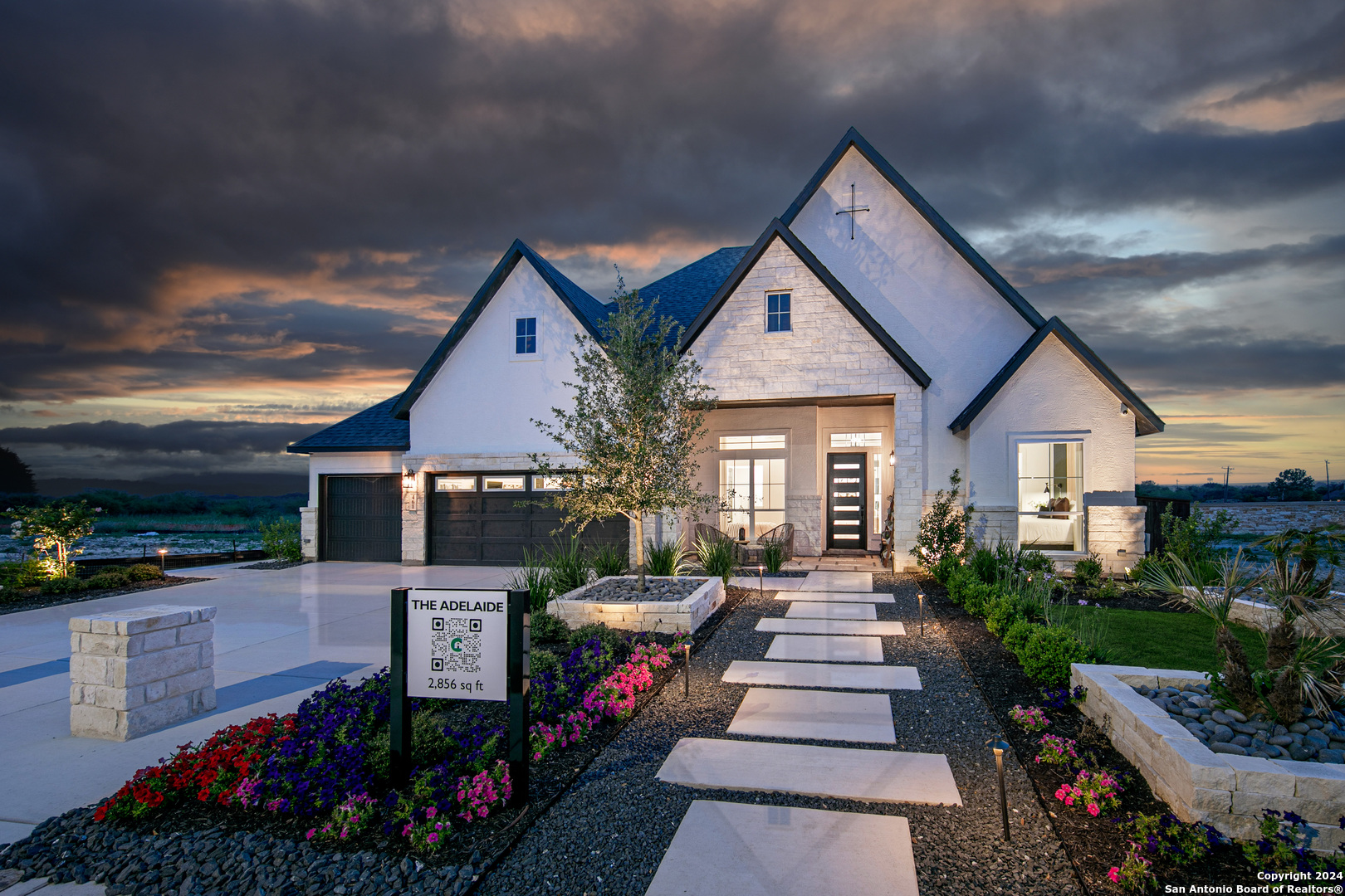 a front view of a house with a garden and patio