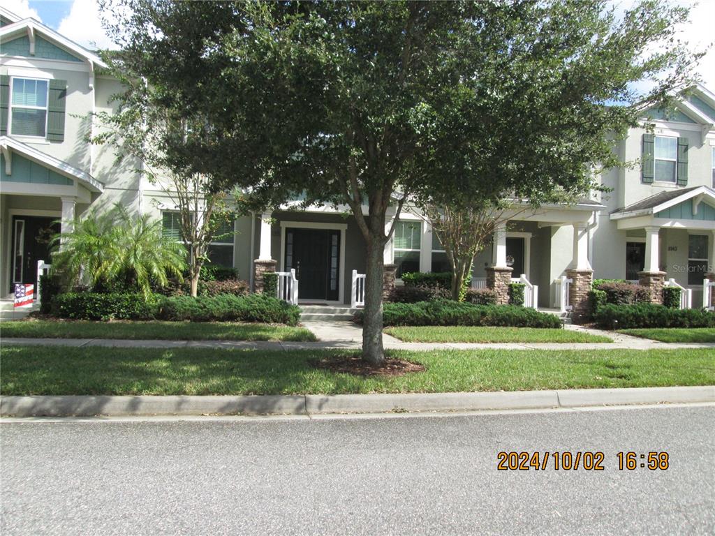 a front view of a house with a garden