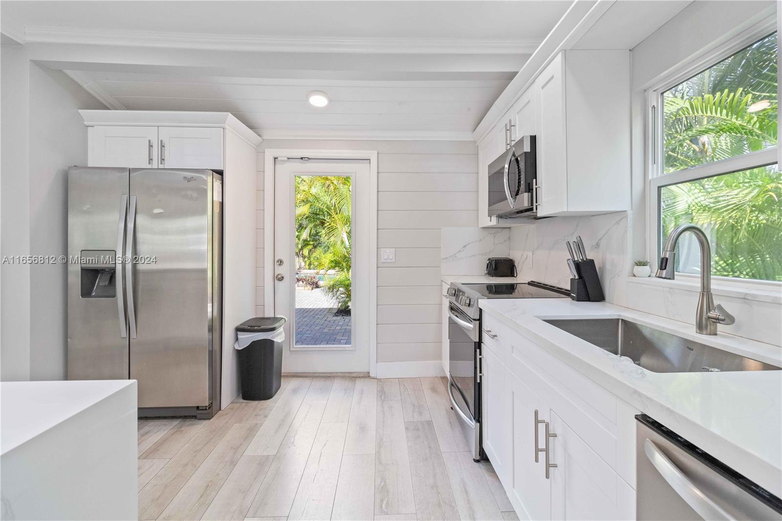 a kitchen with a refrigerator sink and stove