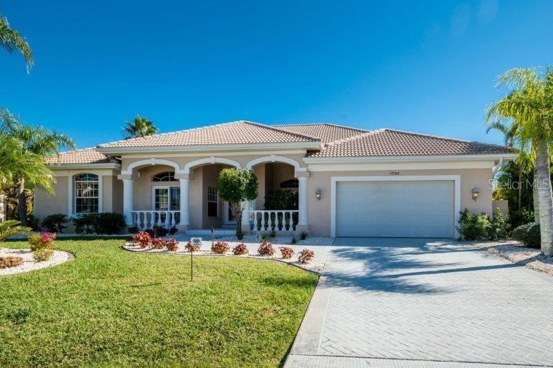 a front view of a house with yard and green space