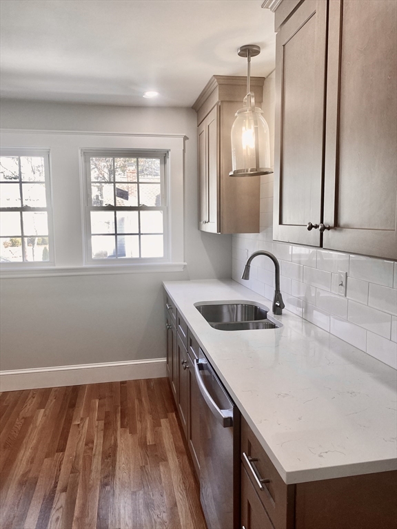 a kitchen with a sink window and cabinets