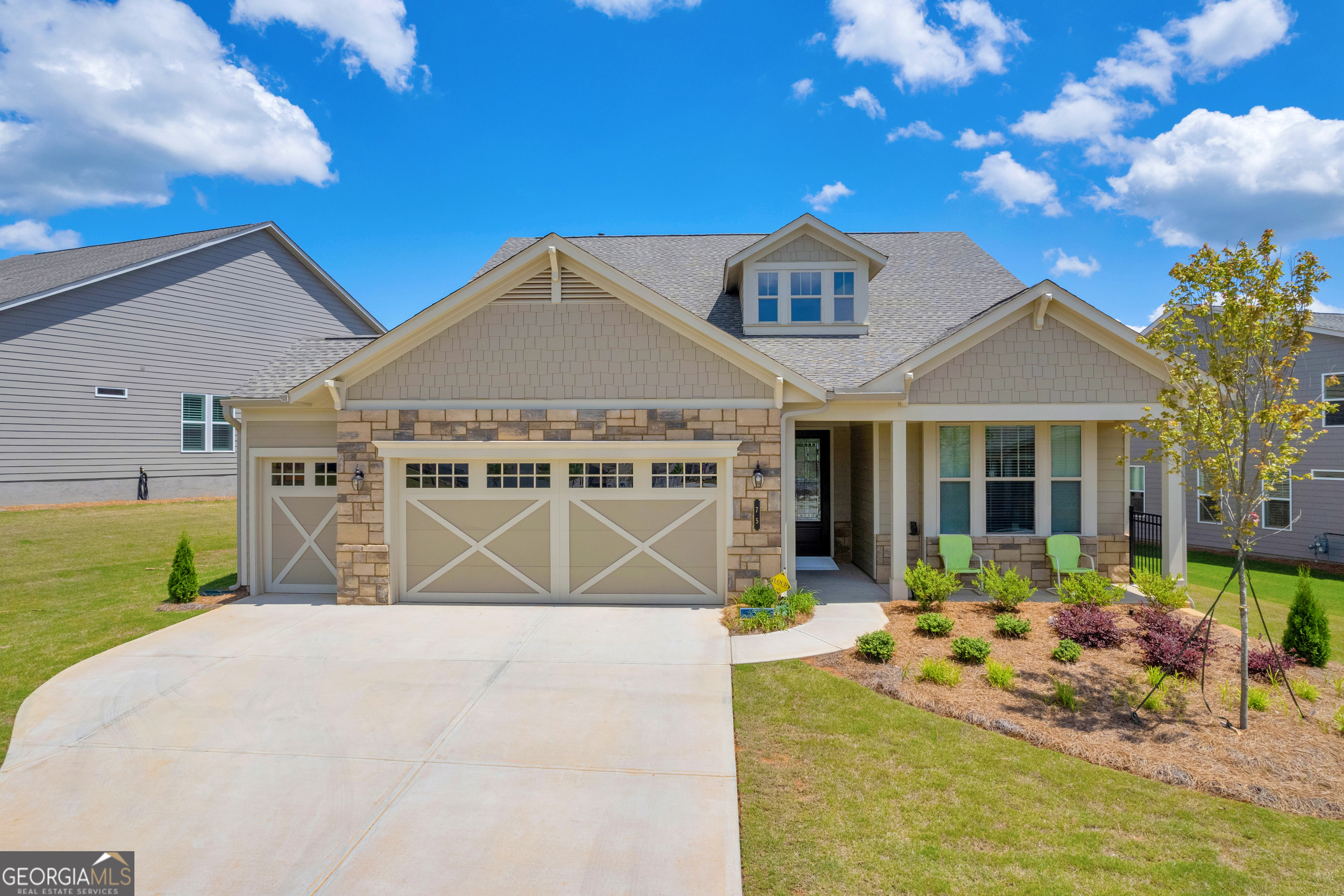 a front view of a house with a porch and a yard