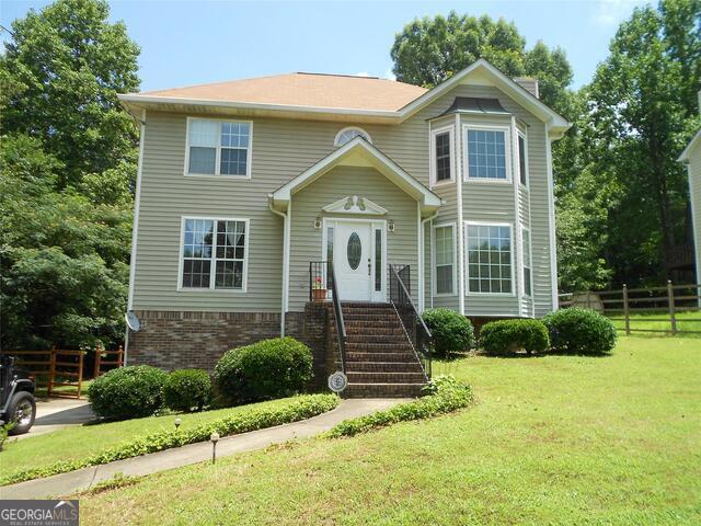 a front view of a house with a yard