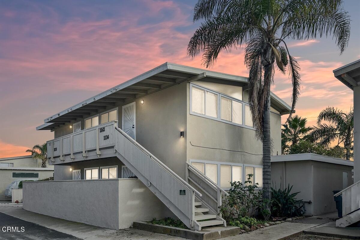 a view of a house with a palm tree