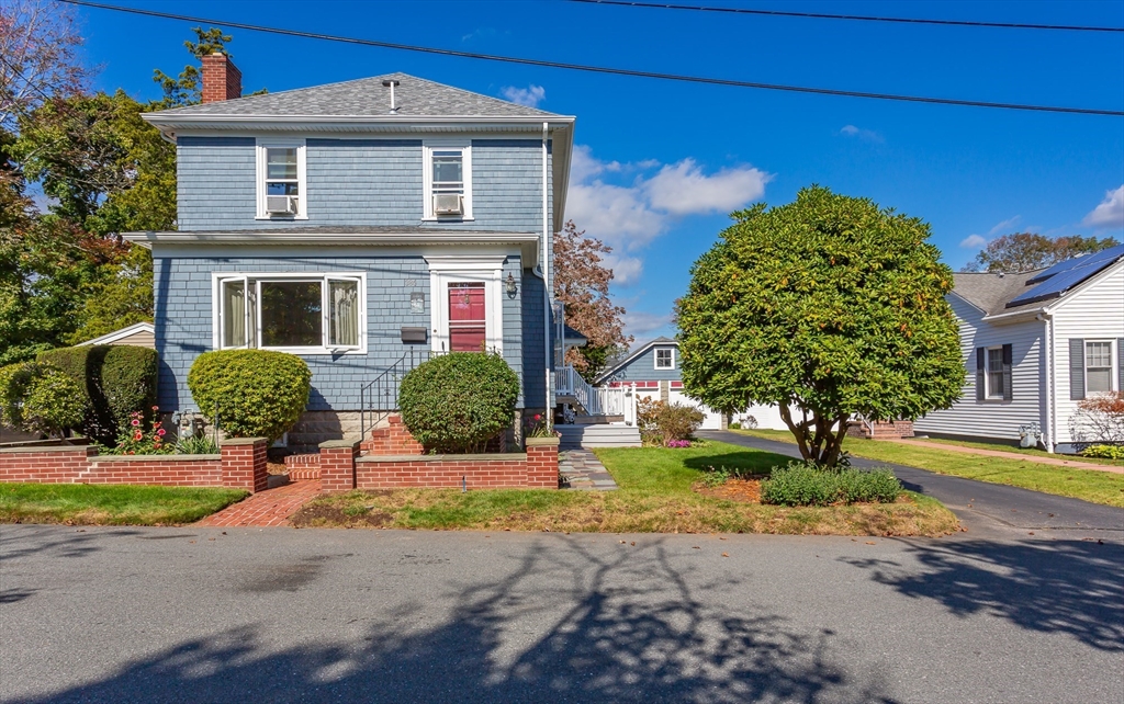 a front view of a house with garden