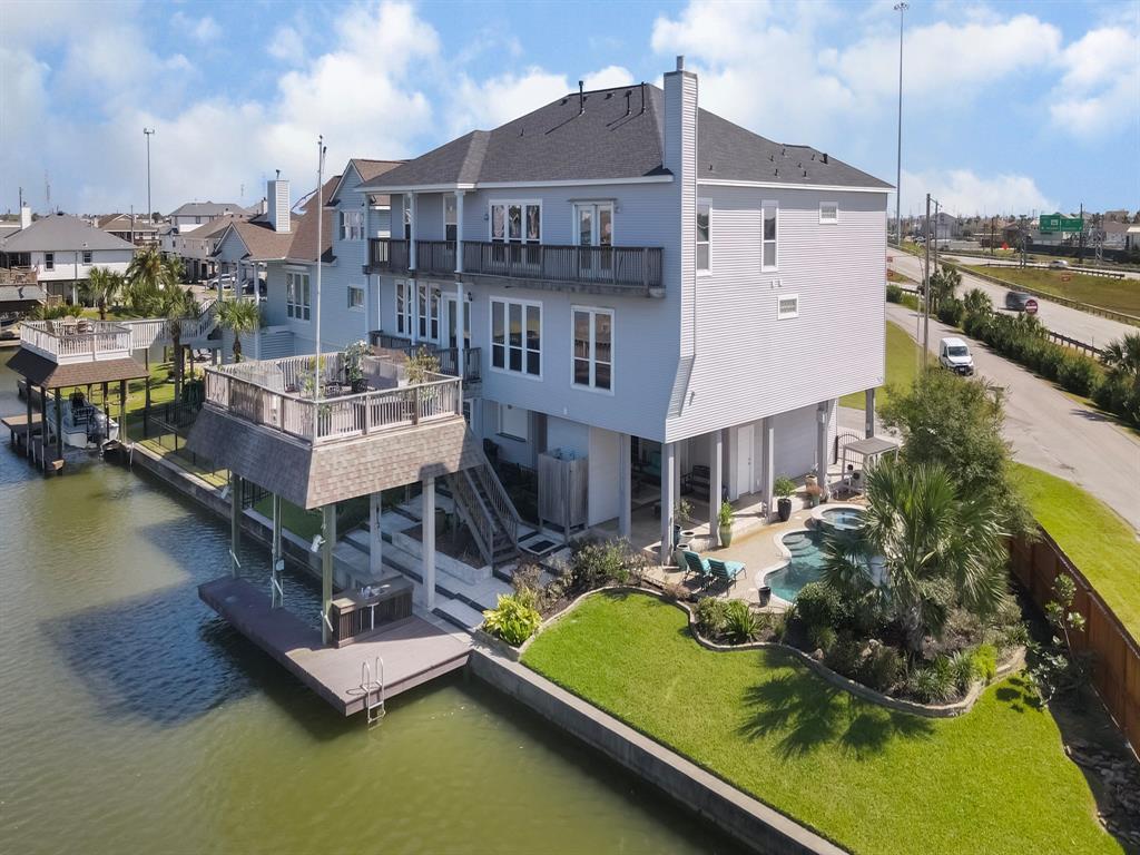 Magnificent Massive Custom 4-4.5-2 Canal Front home with Amazing Saltwater heated pool with spa with jets and beautiful waterfalls. 6280 sq. ft. (Seller).Oversized lot, Boathouse, Party Deck, Elevator.  Inside and outside stairs.