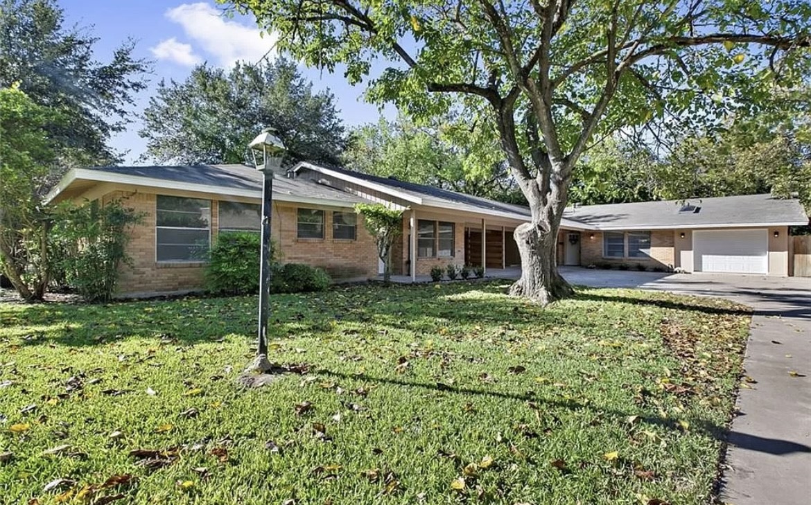 a front view of a house with garden