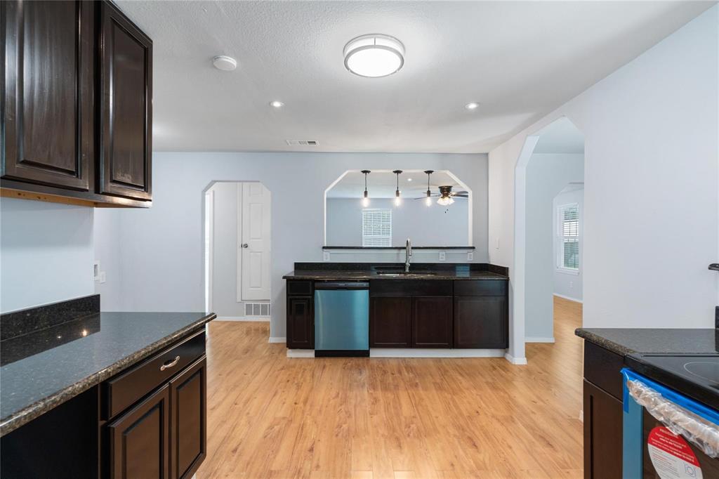 a kitchen with granite countertop stainless steel appliances and wooden cabinets