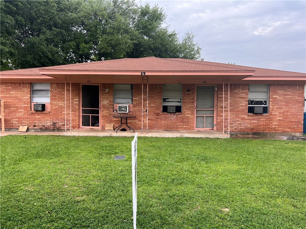 Rear view of property with a yard and cooling unit